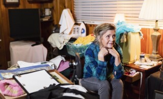 Senior woman at home in a messy room
