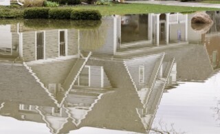 Reflection of suburban home in stormwater flood