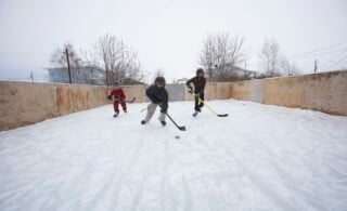 Kids Playing Ice Hockey on a DIY Backyard Rink