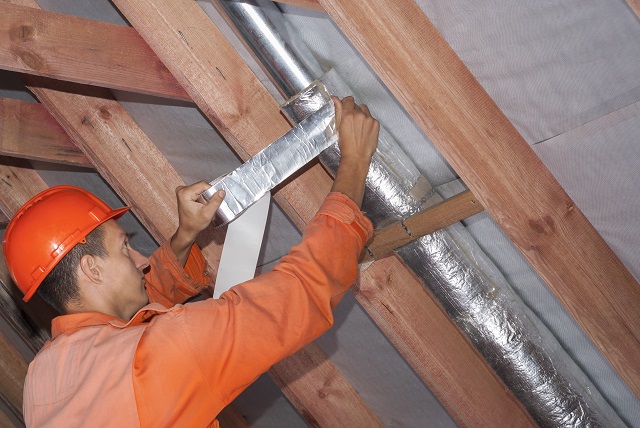 installer wraps the air duct with mineral wool and foil