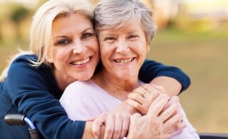 daughter embracing mother with alzheimers