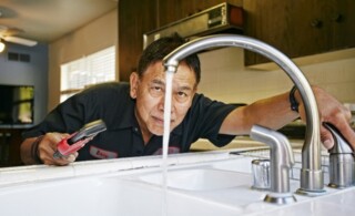 Plumber fixing a kitchen sink