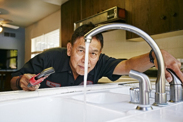 Plumber fixing a kitchen sink