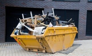 full dumpster outside of property