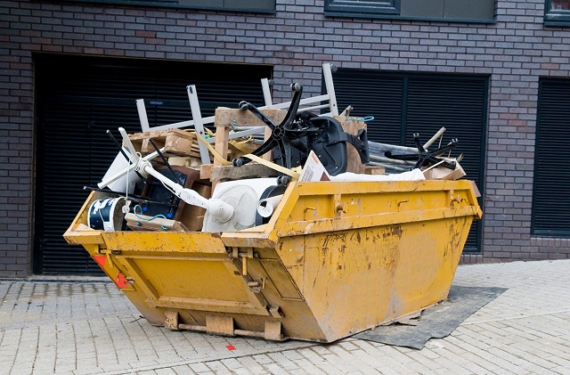 full dumpster outside of property