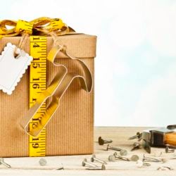 Gift with hammer decoration and gift tag nailed to gift box.