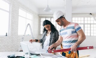 Woman managing home remodel with professional