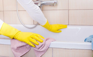 woman cleaning a bathtub