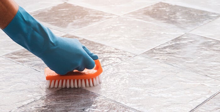 hand washing a tile floor