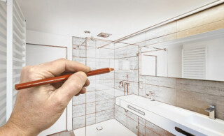 man draws plan for his bathroom remodel