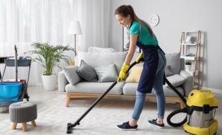 professional maid vacuuming a carpet