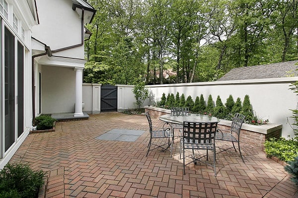 Brick patio on the side of a house