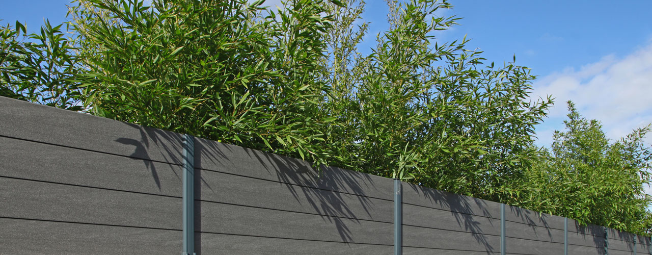 Composite wood fence with trees