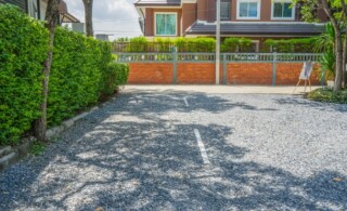 gravel yard with tree and house