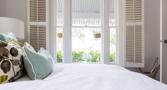 interior shutters in a bedroom