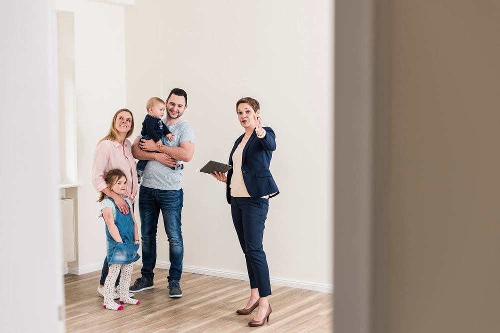 Property manager showing young family a new apartment