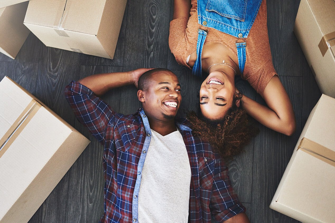 couple on floor around moving boxes