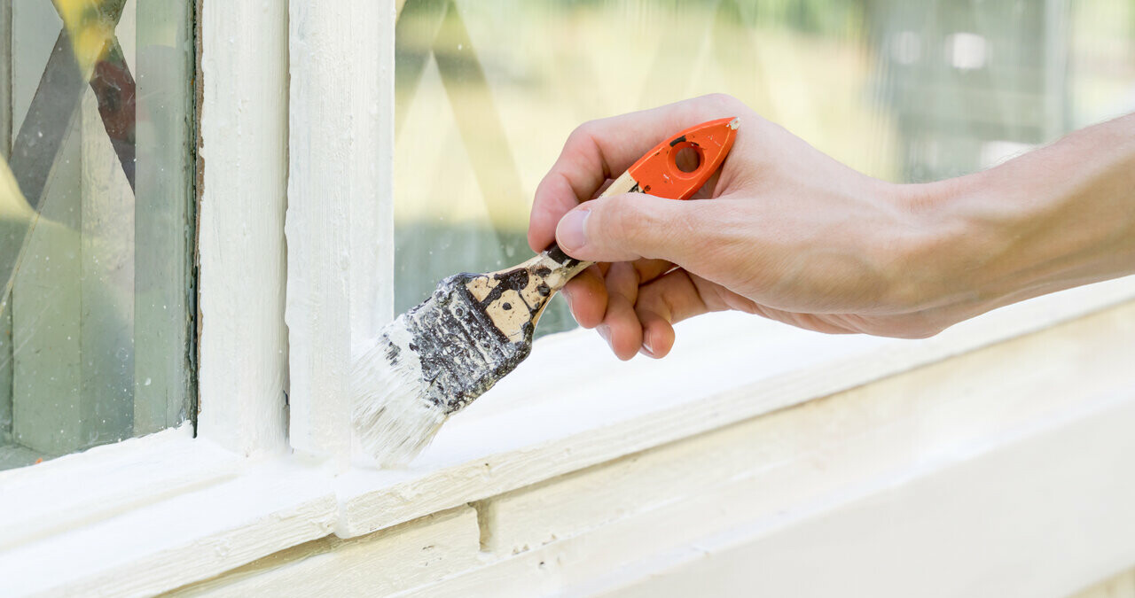 painting white paint on window sill