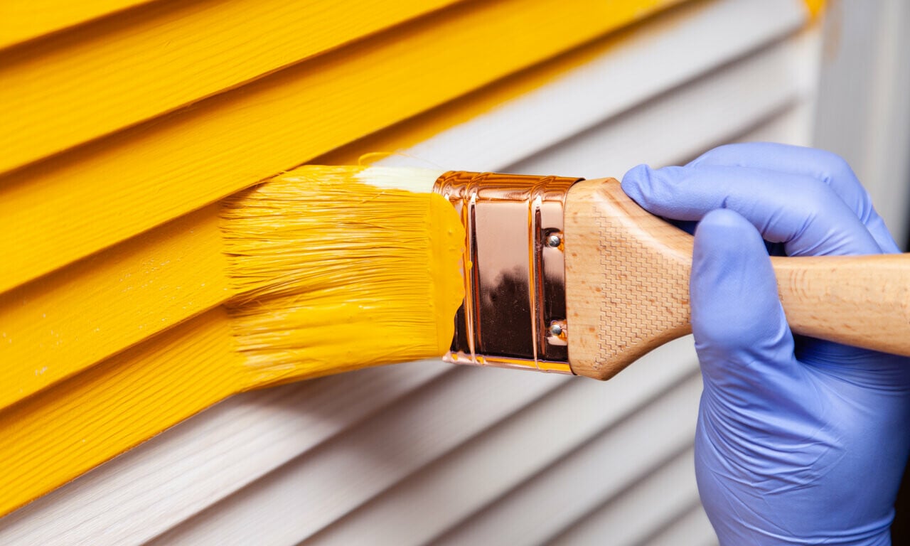 yellow paint brushed onto outdoor of home