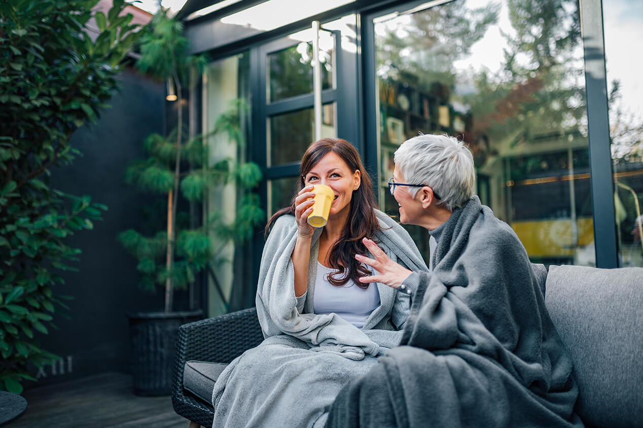 two women outside with blankets
