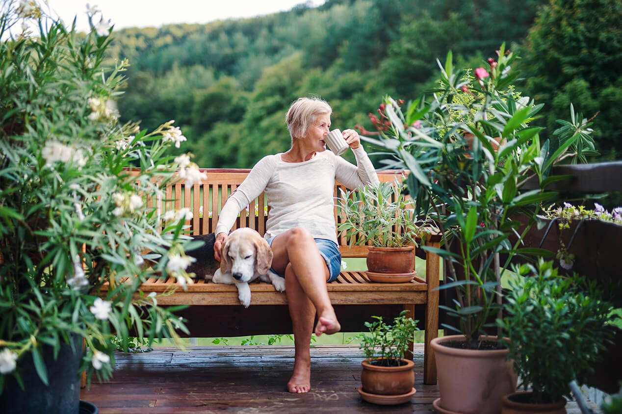 woman outside on garden bench