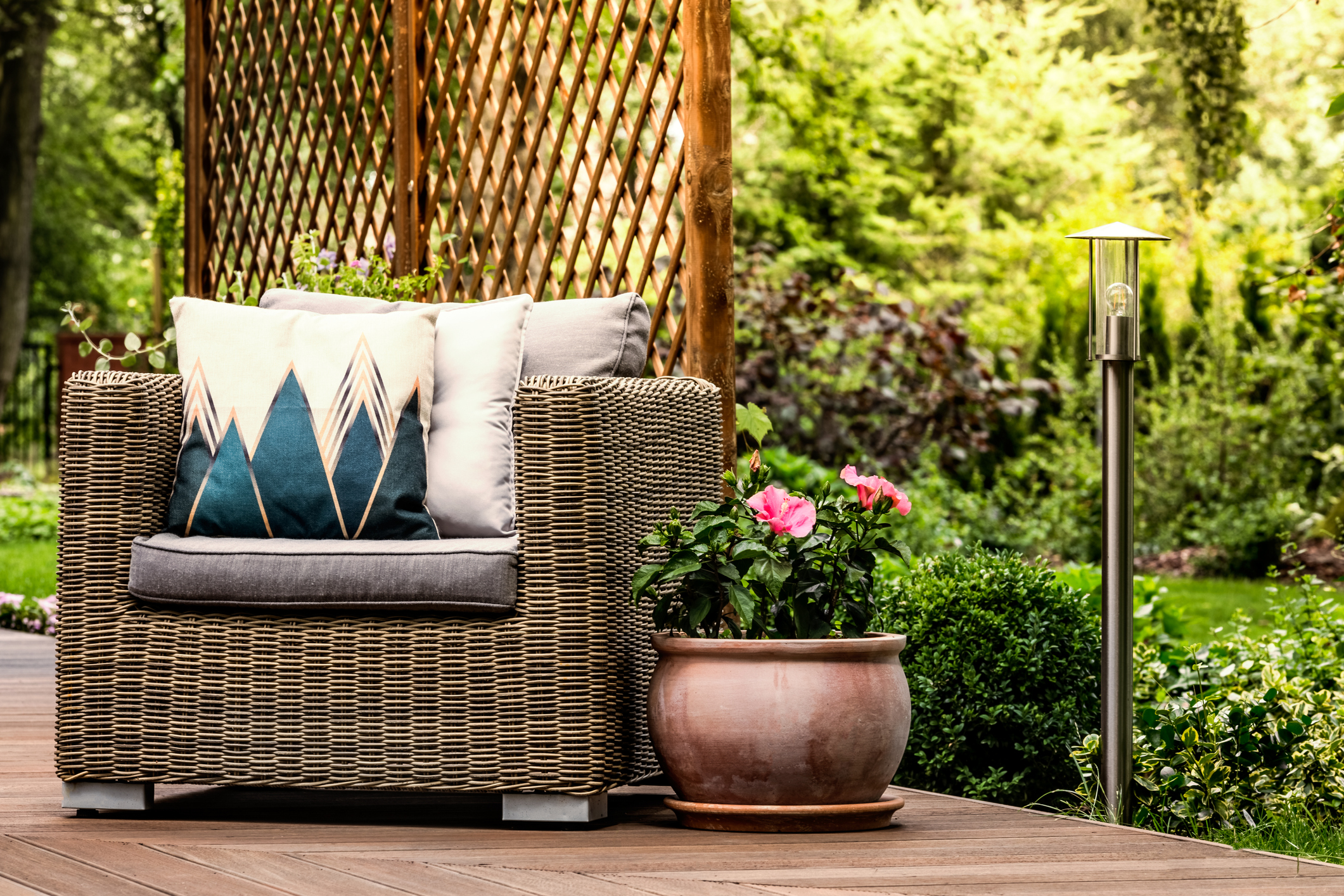 Rattan armchair on wooden terrace