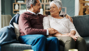 Couple sitting on couch together smiling