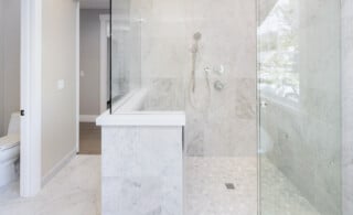 white bathroom with tile shower floor