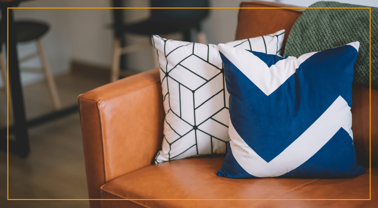 Blue and white pillows sitting on couch