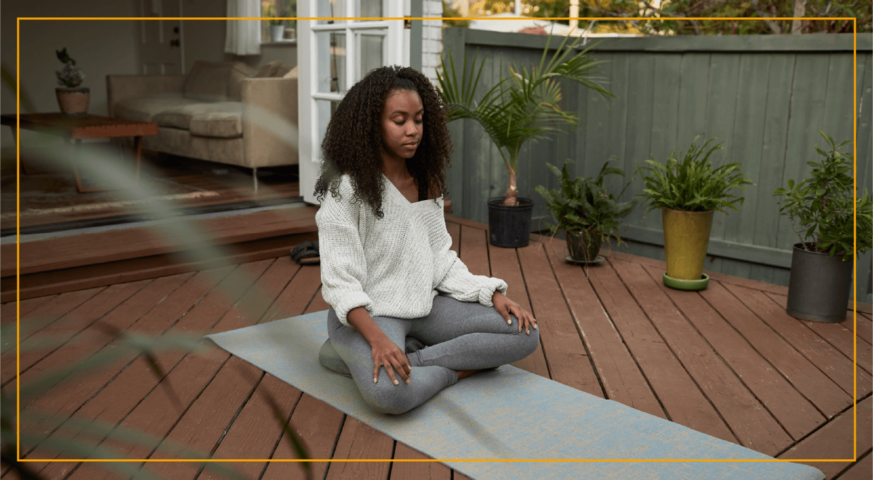 Young woman doing yoga in outdoor patio