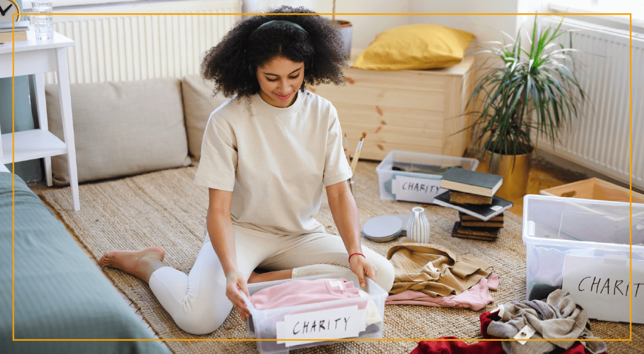 Woman sitting on floor organizing a plastic bin