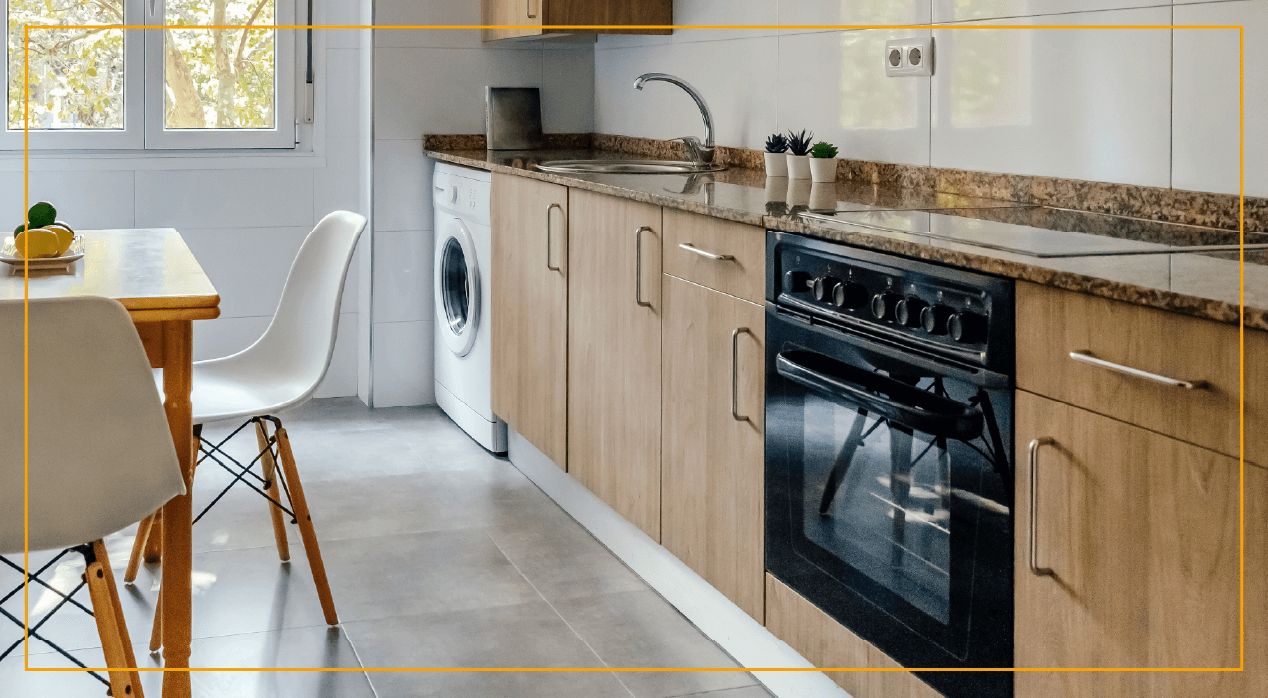 Kitchen with washer/dryer, oven, and sink