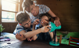 Mother and children using energy efficient light bulb