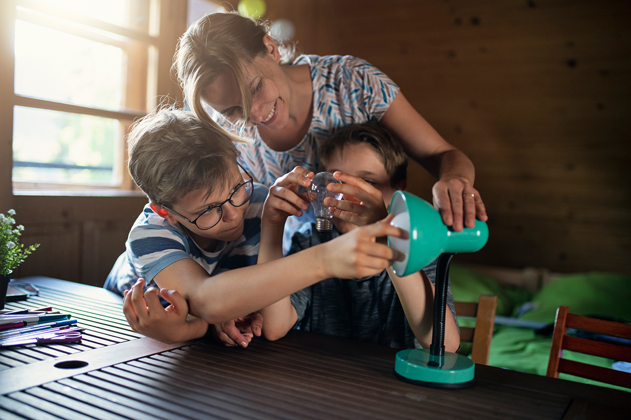 Mother and children using energy efficient light bulb