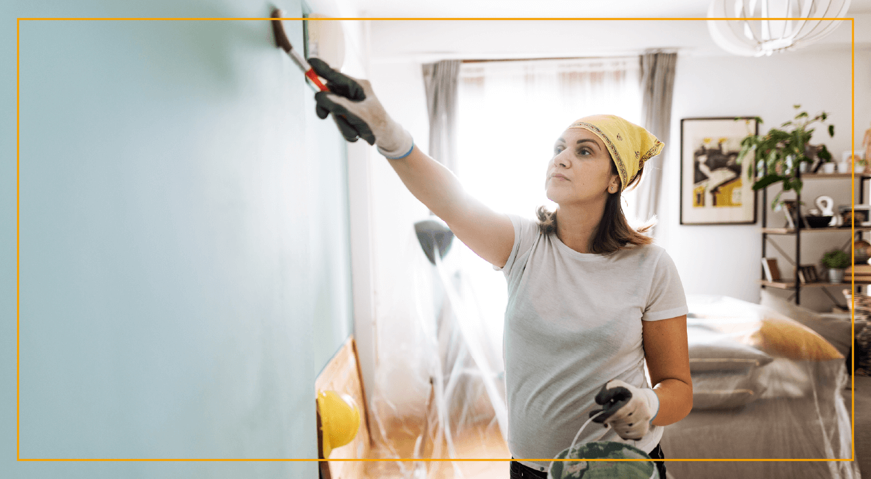 Woman painting wall 