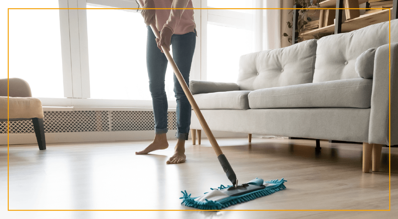 Mopping hardwood floor in living room