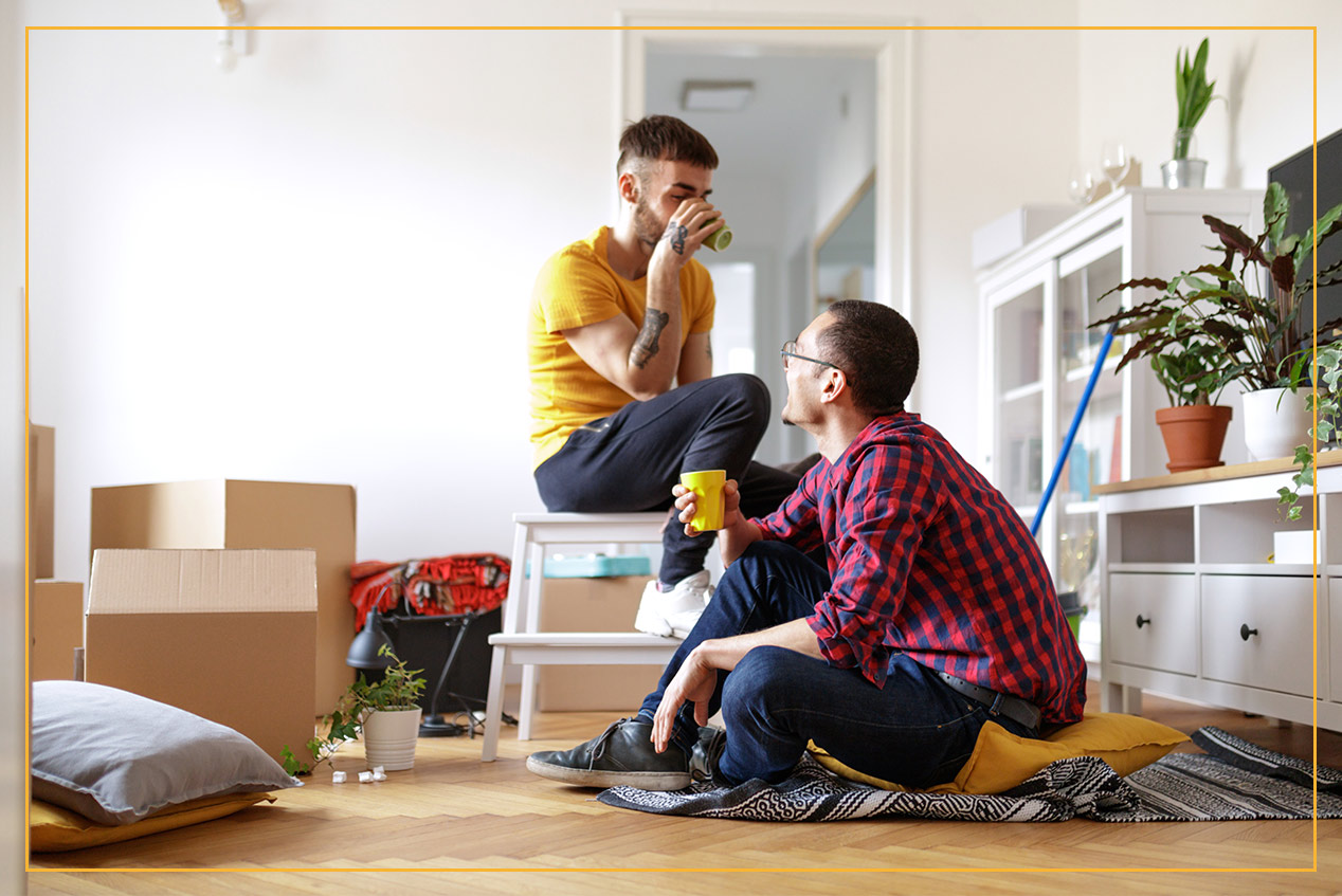 couple unpacking a box in new home