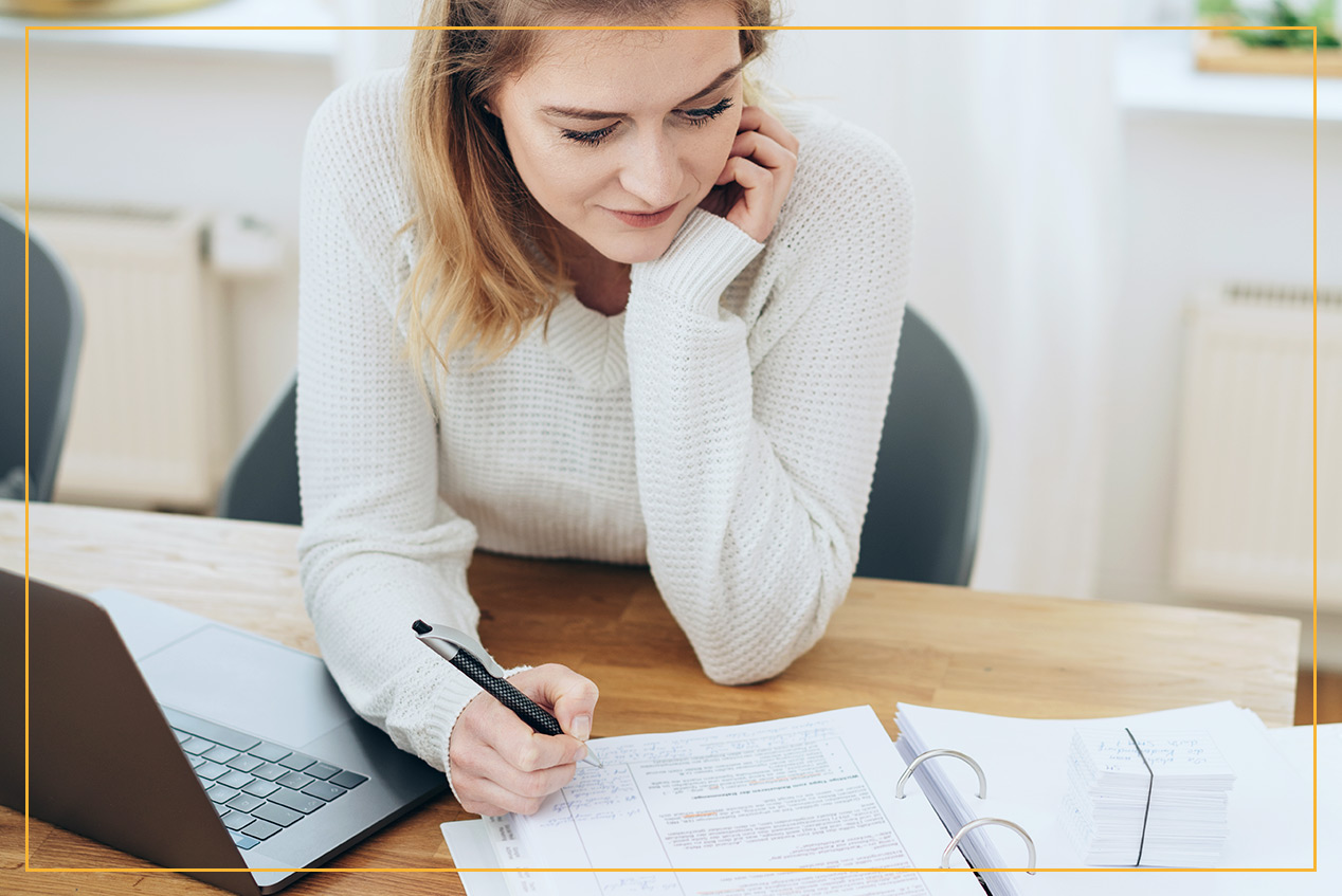 Woman checking binder and making notes