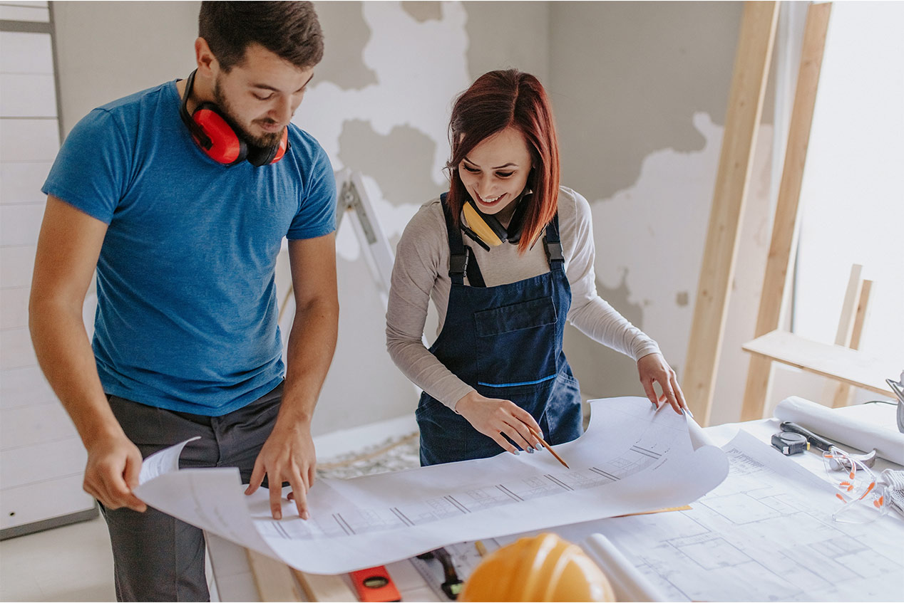 couple looking at blueprint of home