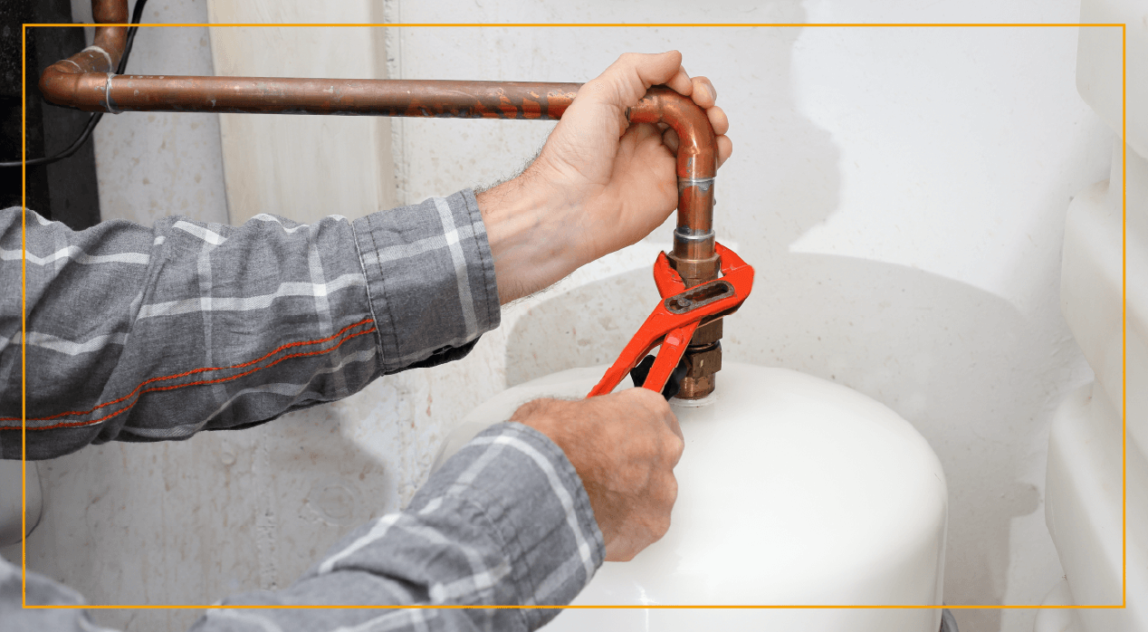 Man using wrench to tighten heating pipe 