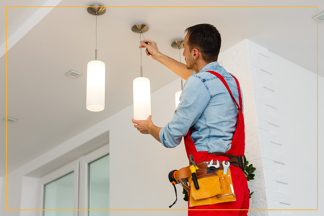 electrician installing a light fixture