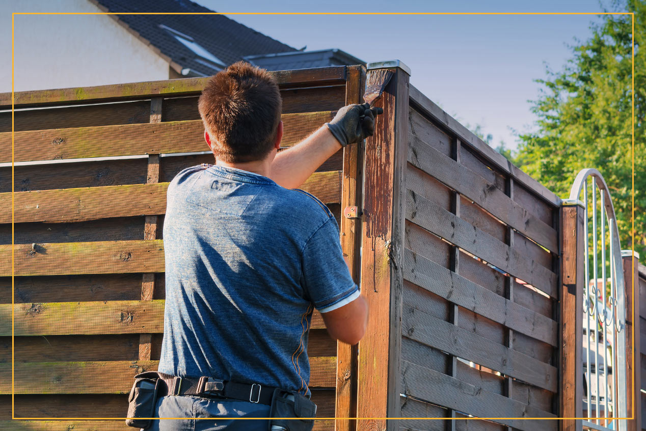 man painting fence