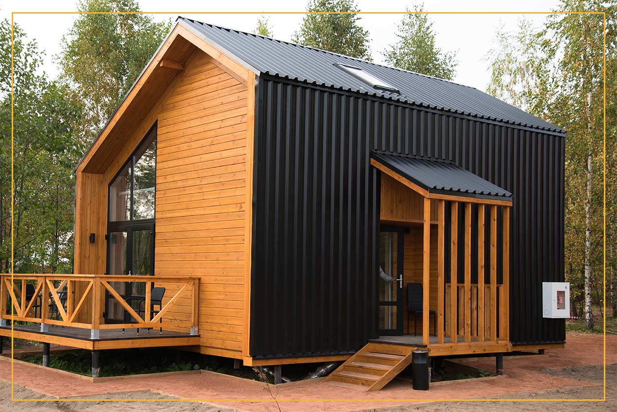 House in forest made of metal siding and logs