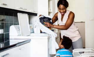 mom and son doing laundry together