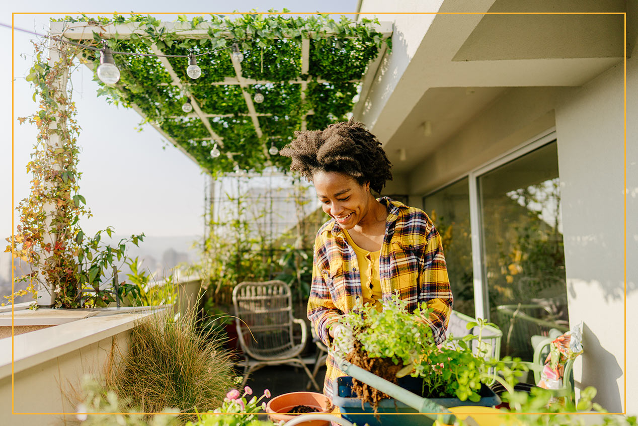 woman under awning with plants