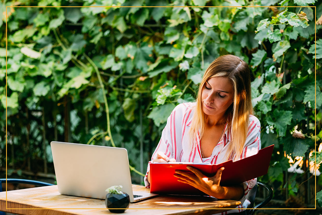 woman working by greenery in backyard