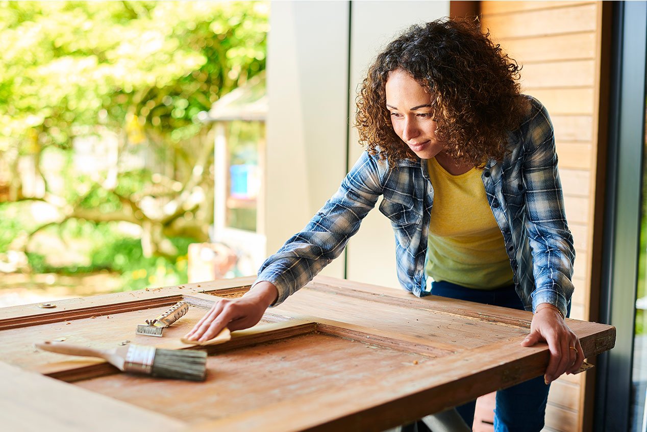 woman sanding a door