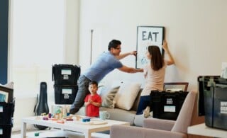 couple hanging photograph on wall