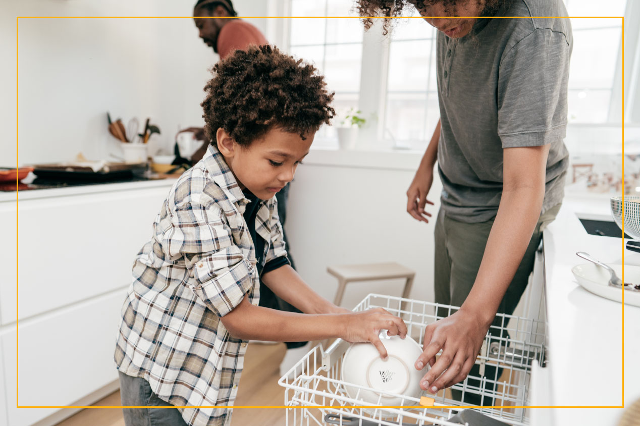 family cleaning in kitchen and washing dishes