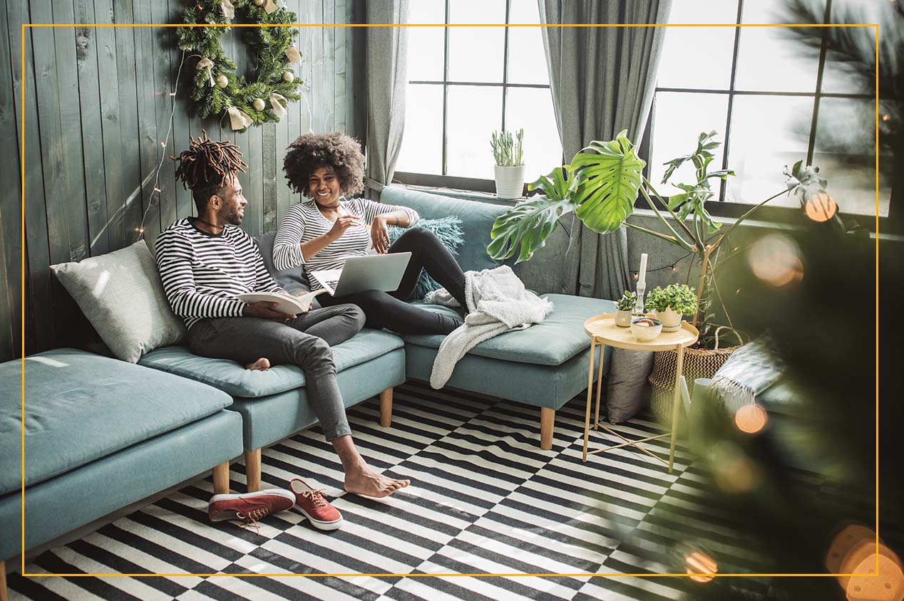 couple on couch in living room with winter decor